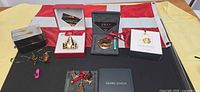 Overview of six Georg Jensen ornament boxes, loose ornaments, Danish and Canadian flags, and bracket