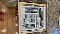 Drawer organizer showing majority of flatware and utensils