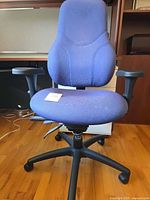 Front view showing full chair, upholstery, armrests, base