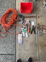 All items laid out including extension cord, bin, tools, hardware