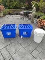 Front view of two blue recycling bins with lids and white bucket