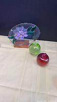 Full lot: stained-glass panel with two blown-glass apples