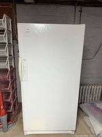 Front view of white Kenmore upright freezer