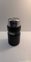 Closed Thermos black insulated food jar