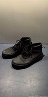 Pair of black Dr. Martens boots side view