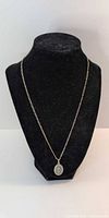 Necklace on display bust showing chain length and pendant