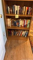 Full view of bookcase with three shelves of books