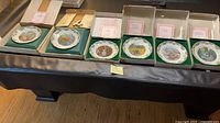 Six boxed Poetry of Love plates displayed on table