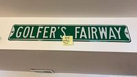 Full view of metal Golfer’s Fairway sign on wall
