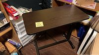 Full view of overbed table with laminate top and metal base