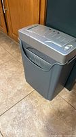 Full view of paper shredder beside cabinet