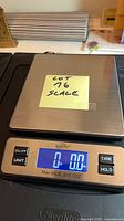 scale powered on showing 0.00 lb with note indicating lot number