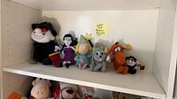 All six plush characters arranged on shelf