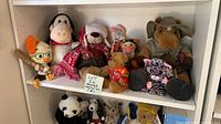 Full view of top shelf with eight plush toys