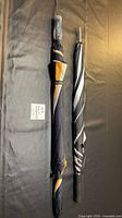 Both umbrellas side by side showing full length and designs