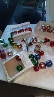 table of assorted vintage ornaments, boxed and loose