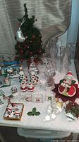 Overview showing tabletop tree, figurines, cone trees, crystal train, snow globes, candy jars