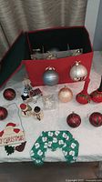 All items on table including storage box, ornaments, candlesticks, shakers, crystal ornament and stocking holder