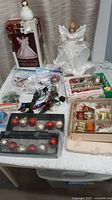Overview of lot showing angels, boxed bulbs, Bakelite covers, ornaments, flower covers, light string