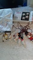 Group view of all items including star toppers, NOMA box, loose bulbs, figural light string