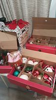 Overall view of multiple open cardboard trays filled with assorted ornaments