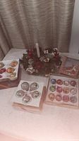 Overall lot showing wreath centerpiece, three boxes of ornaments, Sandicast dog ornament box