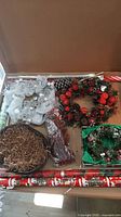 Overview of wreaths, pine cones, twigs, wrapping paper