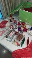 Entire lot laid out with ornaments, Santa hat, candle, reindeer and storage box visible