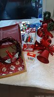 Overall lot showing wreath in box, bell cluster, bulb card and tinsel packs