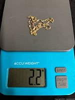 Chain on digital scale showing 2.2 g