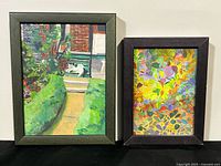 Two framed paintings side by side