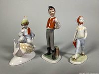 Front view of three porcelain figurines
