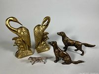 Pair of brass swan bookends and three dog figurines group shot