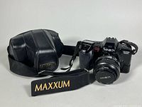 Camera, lens, strap, and case overview