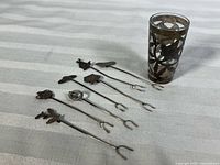 Seven sterling silver picks and overlay shot glass