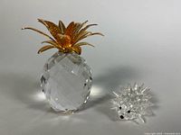 Pineapple and porcupine figurines side by side