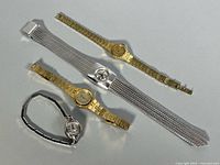 Group shot of four wristwatches showing overall styles and bracelets