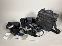 Overall lot showing camera, lenses, flash, bag and accessories