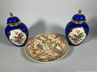 Full view pair of cobalt blue urns and abstract plate