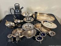 Group shot of all silver-plated pieces displayed on table