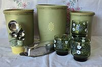 Group shot showing all items including canisters, tumblers, butter dish, teaspoon holder and spoons