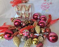 Overview of assorted red and gold ornaments spread on cloth