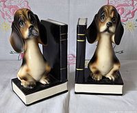 Front view of both ceramic hound dog bookends