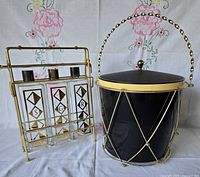 Overall lot showing ice bucket and tantalus with three decanters