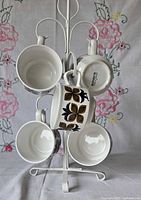 Mugs hanging on white metal stand showing interior and pattern