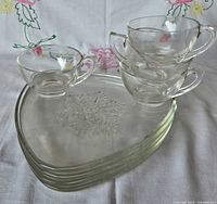 stack of four triangular plates and four cups showing full set