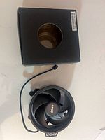 Cooler and box top view showing fan and packaging