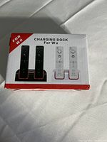 Front of retail box showing white dual charging dock and two Wii remotes