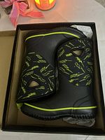 Boots in original box showing side profile and lightning bolt pattern