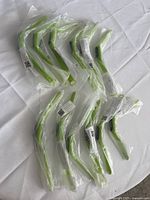 12 individually bagged lime green plastic watches spread on table